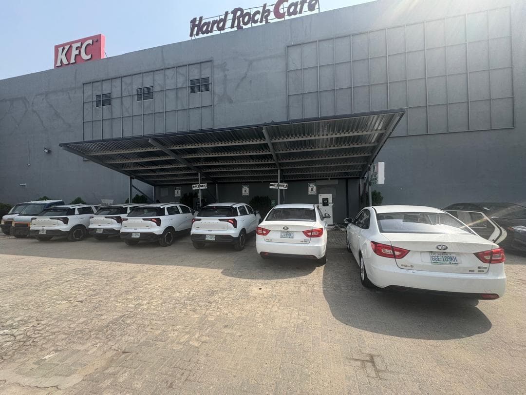 Fleet of electric vehicles parked under a canopy-covered charging bay at Landmark Centre, Victoria Island